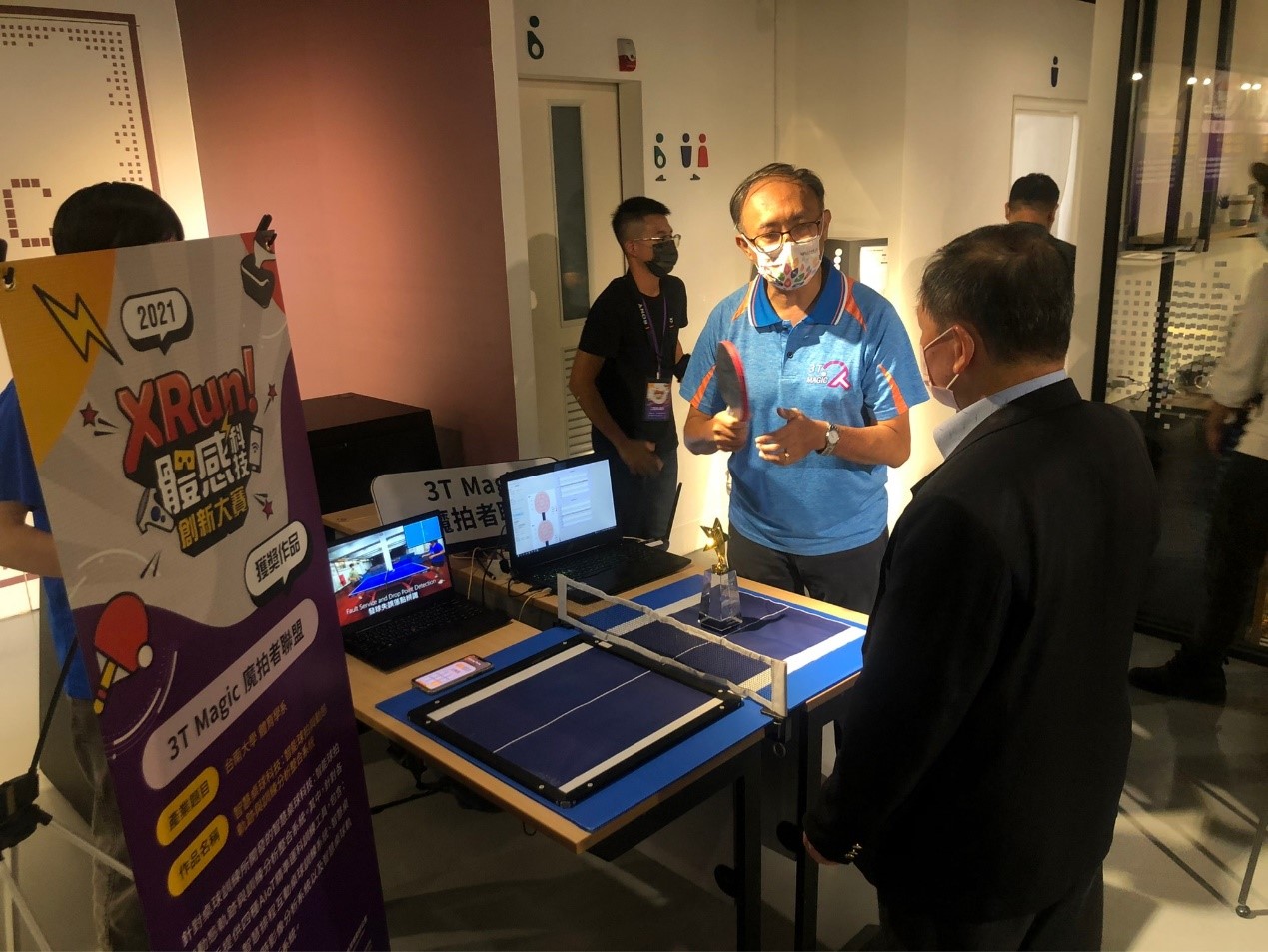 資工系許永和老師(左一)向經濟部工業局 周崇斌主任秘書(右一)說明得獎作品理念